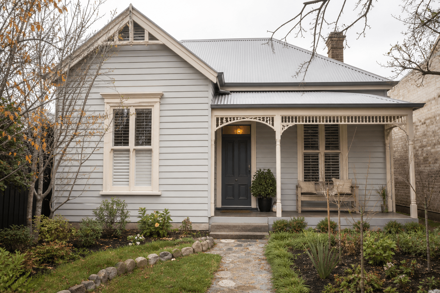 Ballarat-style weatherboard home with pale painted exterior and charcoal door